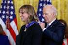 U.S. President Joe Biden presents the Presidential Medal of Freedom to Olympic champion swimmer Katie Ledecky, a Catholic, during a ceremony at the White House in Washington May 3, 2024. 