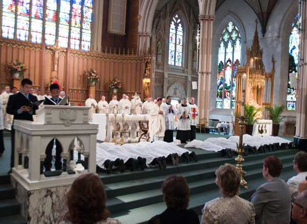 Archdiocese of Toronto's 14 new deacons lie prostrate during their ordination