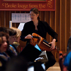 Trisha Postle plays the hurdy gurdy as she musically leads morning prayer from the Divine Office for the feast of St. Joseph, March 26 at Regis College. (Photo by Michael Swan)