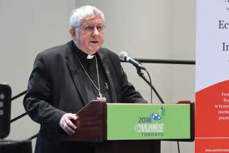 Cardinal Thomas Collins, in a session called “Welcome the Stranger,” speaks at the Parliament of the World’s Religions in Toronto Nov. 6. 