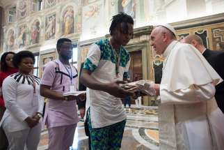 Pope Francis meets at the Vatican Feb. 12 with Italian young people, adults and migrants rescued from human traffickers. The pope responded to the questions five of the young people asked about preventing trafficking and assisting survivors. 
