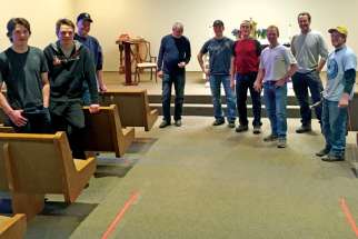 Parishioners at St. Emerence installed new pews as part of extensive renovations of their church in Rivière Qui Barre, northwest of Edmonton.