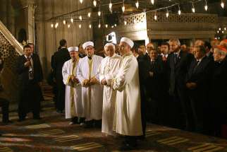 Pope Benedict XVI stands next to Emrullah Hatipoglu, imam of the Blue Mosque, and Mustafa Cagrici, right, the grand mufti of Istanbul, as he visits the Blue Mosque in Istanbul in this Nov. 30, 2006, file photo. The pope&#039;s unexpected prayer next to the mu fti in the mosque soothed anger in the Muslim world over a quote about Islam in his Sept. 12, 2006, lecture in Regensburg, Germany. It was only the second time a pontiff had entered a mosque.
