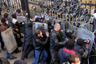 Pro-Russia protesters scuffle with the police at the regional government building in Donetsk, Ukraine, April 6.