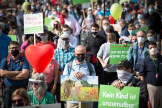 Demonstrators hold red and green balloons and placards at the March for Life in Berlin Sept. 19, 2020. Catholic bishops in the European Union have taken strong issue with language in a proposed EU health care report that characterizes abortion as a human right.