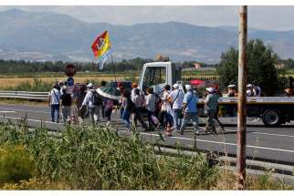 People walk on a highway as they arrive for Pope Francis&#039; Mass attended by 250,000 people in Sibari, in Italy&#039;s region, June 21. During his homily, the pope said &quot;mafiosi&quot; are not in communion with God and are excommunicated. The Calabria region is home of the &#039;Ndrangheta crime organization, known for drug trafficking.