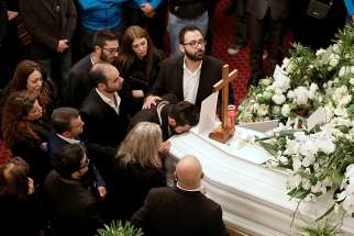 Friends and relatives of Elias Wardini, a Lebanese man killed in a gun attack on the Reina nightclub in Istanbul, mourn during his Jan. 3 funeral Mass at the Church of Our Lady in Beirut. At least 39 people were killed and dozens wounded in the New Year&#039;s Eve attack on the nightclub.