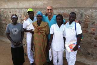 Dr. Tom Catena is pictured with his medical team in outside Mother of Mercy Hospital in Gidel, Sudan, in 2013. Catena, a U.S. Catholic physician and missionary who serves in Sudan, has received the Aurora Prize for Awakening Humanity.