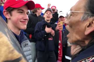 Nick Sandmann, a junior at the time at Covington Catholic High School in Park Hills, Ky., and other students from the school stand in front of Native American Nathan Phillips near the Lincoln Memorial in Washington in this still image from video Jan. 18, 2019. CNN has reached a settlement with Sandmann, who had sued the news outlet saying it defamed him.