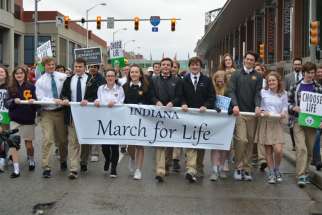 Students from St. Theodore Guerin High School in Noblesville, Ind., carry a banner during the Indiana March For Life in Indianapolis Jan. 22, 2018. After a nearly two-year legal battle, an unlicensed abortion facility started booking appointments in a location in South Bend, Ind., June 19, 2019, and planned to begin offering chemical abortions the week of June 23 amid strong objections from the local community.