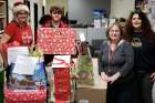 Kathryn Oswin-Groh (left in Santa hat) and Michelle Perkins-Ball (far right) lead the St. Oscar Romero Secondary School Share Christmas campaign. The annual campaign brings the spirit of Christmas into the community.