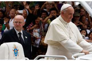 Pope Francis is expected to visit Ecuador, Bolivia and Paraguay this year. In this photo, Domenico Giani, commander of the Vatican police force, keeps watch as Pope Francis arrives to celebrate Mass in Manila, Philippines Jan. 16, 2015. 