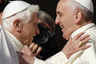 Pope Francis greets retired Pope Benedict XVI during an encounter for the elderly in St. Peter&#039;s Square at the Vatican Sept. 28, 2014.