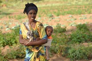 A mother and child on farmland managed by Development and Peace in Ethiopia 2015. 