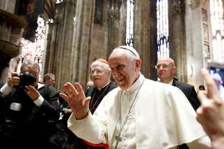 Pope Francis is accompanied by Cardinal Angelo Scola of Milan as he greets people during a meeting with clergy and religious at the Duomo in Milan March 25. The pope was making a one day visit to Milan.