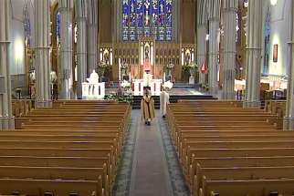 Cardinal Thomas Collins walks up the aisle at an almost-empty St. Michael’s Cathedral Basilica to open the broadcast of Easter Sunday Mass. The broadcast was viewed in more than 55,000 homes.