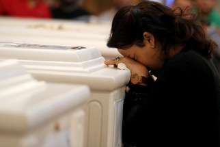 A woman mourns during a Nov. 3 funeral Mass at Prince Tadros Orthodox Church in Minya, Egypt, for a group of Christian pilgrims killed by gunmen as they headed to a monastery Nov. 2.