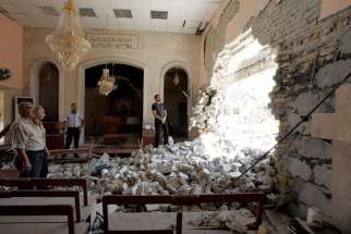 Residents inspect the damage inside St. Ephrem Syrian Orthodox Church after a bomb attack in central Kirkuk, Iraq in this 2011 photo. 