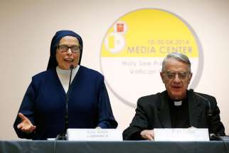 Daughter of Charity Sister Adele Labianca speaks during a press conference at the Vatican April 24 in advance of the canonization of Blesseds John XXIII and John Paul II. At right is Jesuit Father Federico Lombardi, the Vatican spokesman. Sister Labianca gave her eyewitness account of the healing of Sister Caterina Capitani, the nun whose healing in 1966 was accepted as the miracle needed for the beatification of Pope John XXIII. 