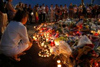 People gather around flowers and burning candles July 17 to pay tribute to victims of the Bastille Day attack in Nice, France. France and Germany are facing challenges of radicalized Muslim youths in their own country.