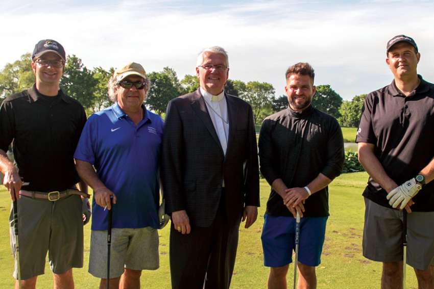 The crew from tournament sponsors Tripemco Burlington Insurance Group: from left,  Kelly Hopkins, Paul Vaccarello, Bishop Crosby, Vince Vaccarello and Tony Filice 