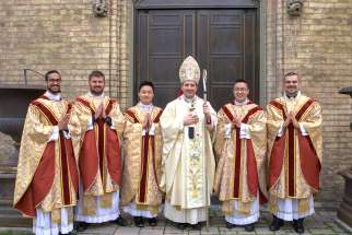 Archbishop Francis Leo stands with the five newly ordained priests for the Archdiocese of Toronto, May 11, 2024.