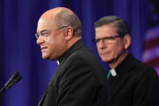 Bishop Shelton J. Fabre of Houma-Thibodaux, La., speaks Nov. 13 at the fall general assembly of the U.S. Conference of Catholic Bishops in Baltimore. Looking on is Archbishop Gustavo Garcia-Siller of San Antonio. 