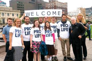 Archbishop Terrance Prendergast, right, greets Crossroads Walkers as they complete their pro-life walk across Canada in Ottawa.