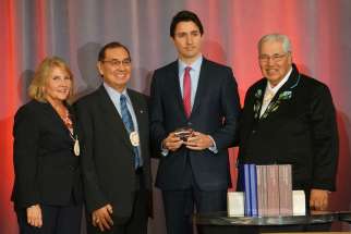 Truth and Reconciliation Commission commissioners Marie Wilson and Chief Wilton Littlechild, Prime Minister Justin Trudeau and TRC chair Justice Murray Sinclair Dec. 15 at the closing ceremony of the TRC.