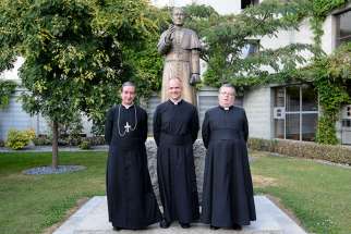 Father Davide Pagliarani, 47, center, was elected July 11 as the new superior general of the traditionalist Society of St. Pius X during the society&#039;s general chapter in Econe, Switzerland. Father Pagliarani is pictured after his election with his assistants, Bishop Alfonso de la Galarreta, left, and Father Christian Bouchacourt. 
