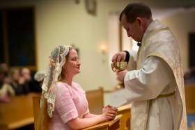 Bree Solstad, formerly a top pornographic content creator, pictured in an undated photo receiving Communion during the Easter Vigil March 30, 2024, recently announced her conversion to Catholicism and her decision to walk away from her previous career.