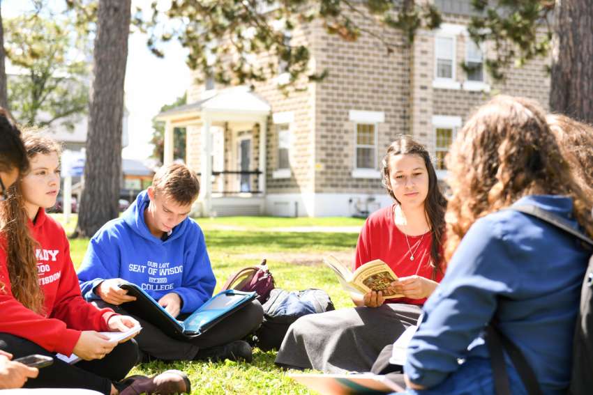A study group at Our Lady Seat of Wisdom College takes its studies outside at the Barry’s Bay, Ont., school. The school will begin granting degrees in the 2024-25 school year.