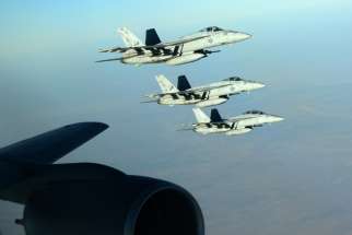 US Navy F-18E Super Hornets make a formation after receiving fuel from a KC-135 Stratotanker over northern Iraq Sept. 23. These aircraft were part of a large coalition strike package that was the first to strike Islamic State targets in Syria. 