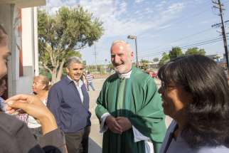 Los Angeles Auxiliary Bishop David G. O&#039;Connell is pictured speaking with parishioners outside St. Frances X. Cabrini Church in Los Angeles July 19, 2015. According to local news reports, Los Angeles County sheriffs found him dead of a gunshot wound at his home Feb. 18, 2023. 