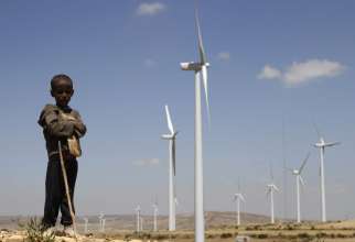 A boy is pictured in a file photo standing in front of wind turbines at the Ashegoda Wind Farm, near Mekele in Ethiopia&#039;s Tigray region.