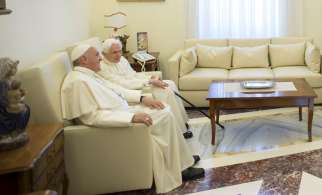 Pope Francis chats with retired Pope Benedict XVI during a meeting at the Vatican June 30. 