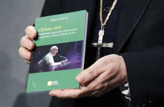 Cardinal Lorenzo Baldisseri, secretary-general of the Synod of Bishops, holds Pope Francis&#039; apostolic exhortation, &quot;Christus Vivit&quot; (Christ Lives), during a news conference at the Vatican April 2. The document contains the Pope&#039;s reflections on the 2018 Synod of Bishops on young people, the faith and vocational discernment. Cardinal Lorenzo Baldisseri, secretary-general of the Synod of Bishops, holds Pope Francis&#039; apostolic exhortation, &quot;Christus Vivit&quot; (Christ Lives), during a news conference for its presentation at the Vatican April 2, 2019. 