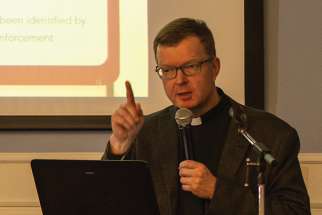 Fr. Hans Zollner addresses a symposium at Regis College March 28 on the scope of problems with children and online porn.