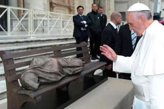 Pope Francis blesses the sculpture &quot;Jesus the Homeless&quot; during his general audience in St. Peter&#039;s Square at the Vatican Nov. 20, 2013. 