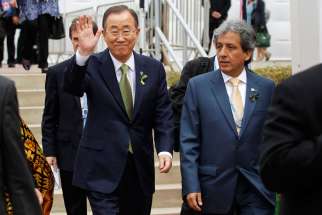 U.N. Secretary-General Ban Ki-moon waves next to Peruvian Environment Minister Manuel Pulgar-Vidal as they arrive for the opening of the U.N. Climate Change Conference in Lima, Peru, Dec. 9. In a message to Pulgar-Vidal, Pope Francis said the time to solve the problem of climate change &quot;is running out.&quot; He also insisted climate change is a serious moral problem.
