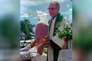 Archbishop Oscar Romero receives a sack of beans from parishioners following Mass outside of the church in San Antonio Los Ranchos in Chalatenango, El Salvador, in 1979. The Italian newspaper, Avvenire, reported today that Oscar Romero will be beatified in San Salvador on May 23, according to the chief promoter of Romero’s sainthood cause, Italian archbishop Vincenzo Paglia.