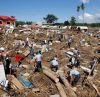 Police search for missing people in a mangled subdivision in Iligan City in southern Philippines Dec. 19. Flash floods brought on by Tropical Storm Washi left at least 650 people dead and tens of thousands homeless. 