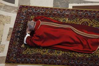 Pope Francis lies prostrate in prayer during the Good Friday service in St. Peter&#039;s Basilica at the Vatican April 19, 2019. 