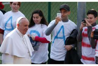 Pope Francis meets with young people while visiting St. Mary Mother of the Redeemer Parish on the outskirts of Rome March 8. 