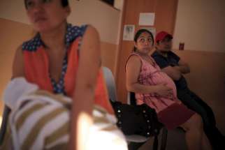 A pregnant woman waits to be seen Jan. 29 at the Women&#039;s National Hospital in San Salvador, El Salvador. The growing number of Zika virus cases in the U.S. has inflamed the abortion debate.