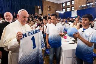 Pope Francis receives a Catholic Charities jersey and an autographed soccer ball Sept. 2015. 