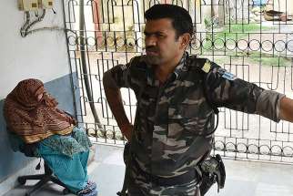 An unidentified Indian woman, allegedly an employee at a home run by Mother Teresa&#039;s Missionaries of Charity, is seen in police custody after she was arrested in Jharkhand, India, July 5. Anima Indwar, who worked for the nuns in Jharkhand, was handed over to police in early July after she admitted that procedures had not been followed in transferring children to Jharkhand state&#039;s Child Welfare Committee. 