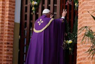 Pope Francis opens the Holy Door at the start of a Mass with priests, religious, catechists and youths at the cathedral in Bangui, Central African Republic, Nov. 29. 