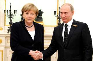 German Chancellor Angela Merkel shakes hands with Russian President Vladimir Putin in May 2015. Cardinal Pietro Parolin says peace and end to violent conflicts should be placed above any national interests when it comes to relationship between Western countries and Russia.
