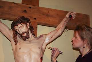 Pauline Winogron working on the restoration of a crucifix.